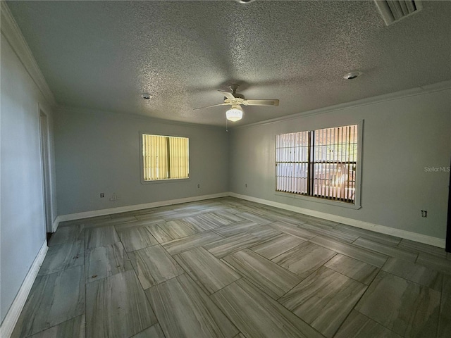 unfurnished room with ornamental molding, ceiling fan, a textured ceiling, and baseboards