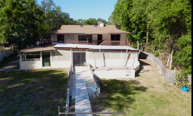 rear view of house featuring a balcony