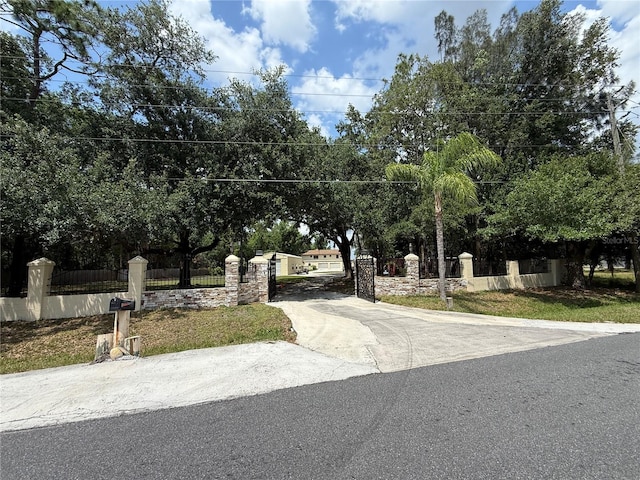 view of concrete surface with a gate and a gated entry