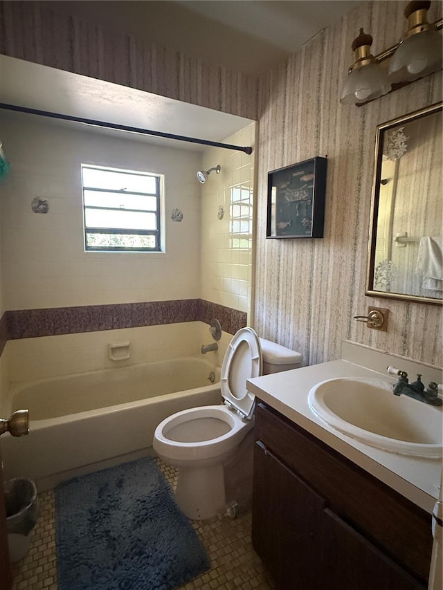 bathroom with washtub / shower combination, wallpapered walls, tile patterned flooring, toilet, and vanity