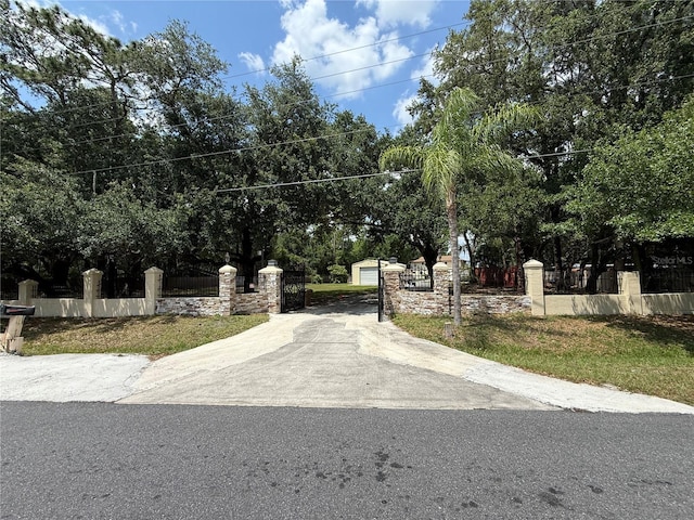 4981 Lake Cecile Dr, Kissimmee, FL 34746 - view of concrete driveway featuring a gated entry