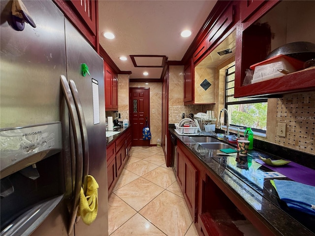 4981 Lake Cecile Dr, Kissimmee, FL 34746 - kitchen with stainless steel fridge, reddish brown cabinets, a sink, decorative backsplash, and recessed lighting