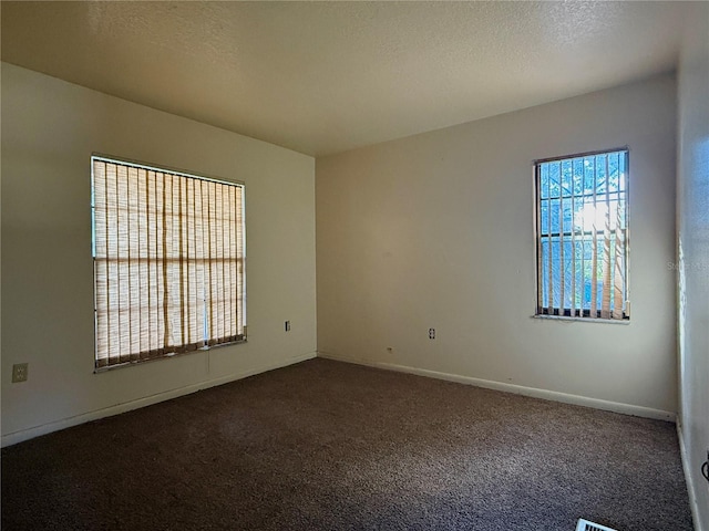 4981 Lake Cecile Dr, Kissimmee, FL 34746 - unfurnished room featuring dark carpet, baseboards, and a textured ceiling