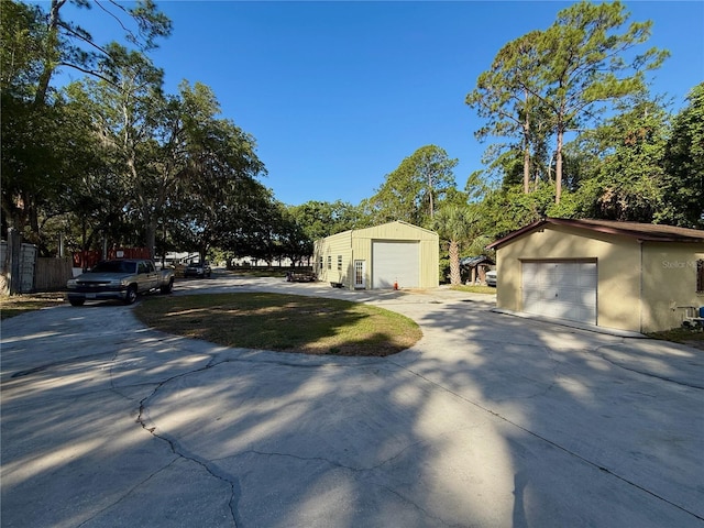 4981 Lake Cecile Dr, Kissimmee, FL 34746 - view of front of property featuring an outdoor structure and a detached garage