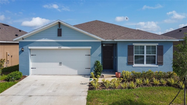 3354 Aruba Way, Haines City, FL 33844 - single story home featuring concrete driveway, stucco siding, an attached garage, and a shingled roof
