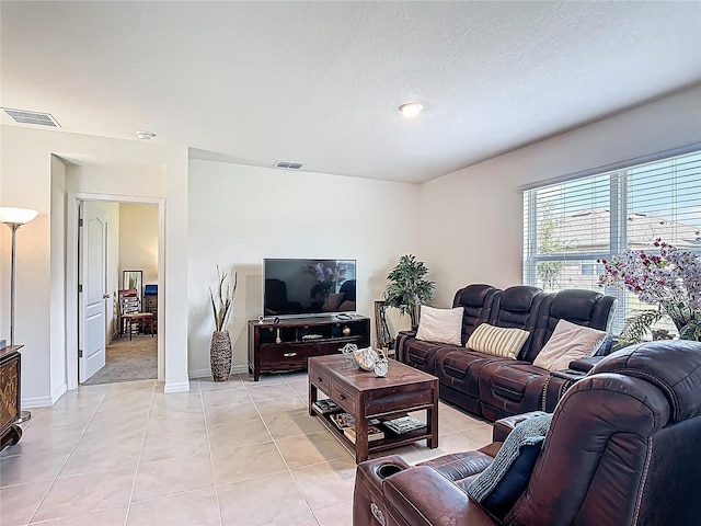 3354 Aruba Way, Haines City, FL 33844 - living room featuring light tile patterned flooring and baseboards