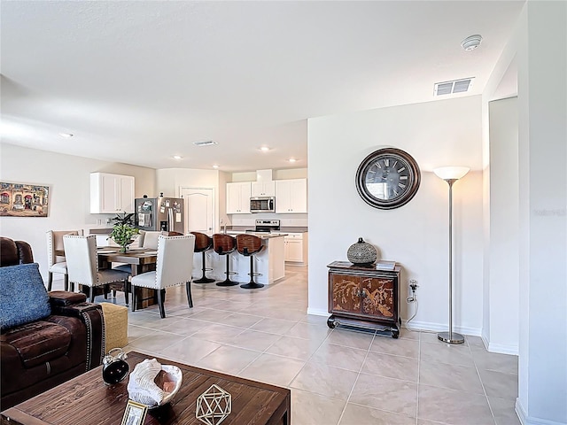 3354 Aruba Way, Haines City, FL 33844 - living room featuring light tile patterned floors, recessed lighting, and baseboards