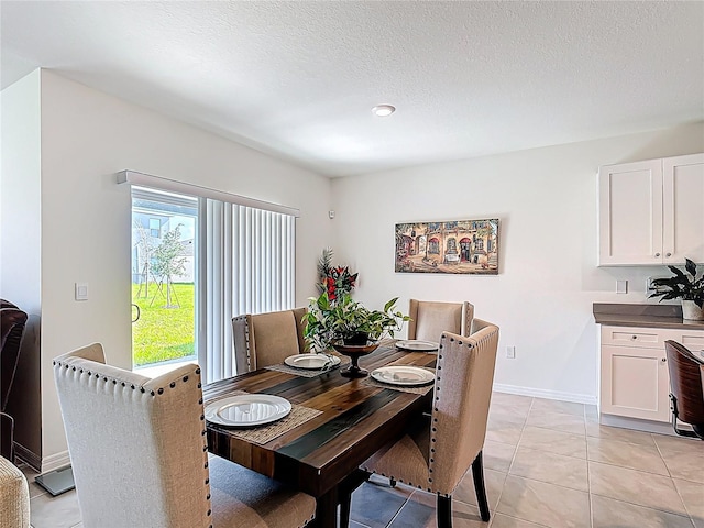 3354 Aruba Way, Haines City, FL 33844 - dining space with light tile patterned flooring, a textured ceiling, and baseboards