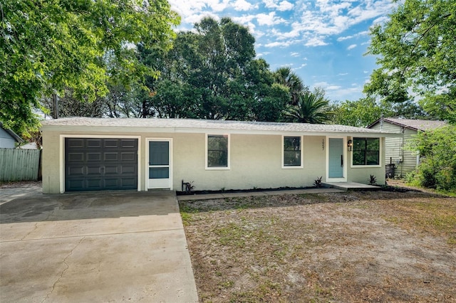 1957 Deloy Dr, Daytona Beach, FL 32119 - single story home featuring a garage, stucco siding, driveway, and fence