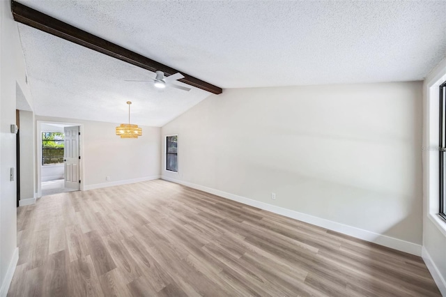 1957 Deloy Dr, Daytona Beach, FL 32119 - unfurnished living room featuring light wood finished floors, a textured ceiling, a chandelier, a ceiling fan, and baseboards