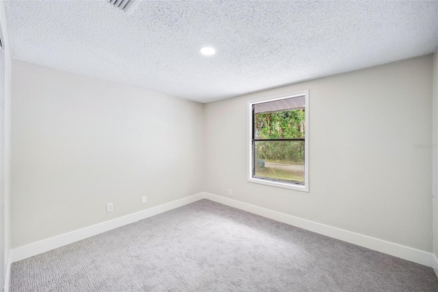 1957 Deloy Dr, Daytona Beach, FL 32119 - spare room featuring baseboards, a textured ceiling, carpet floors, and recessed lighting