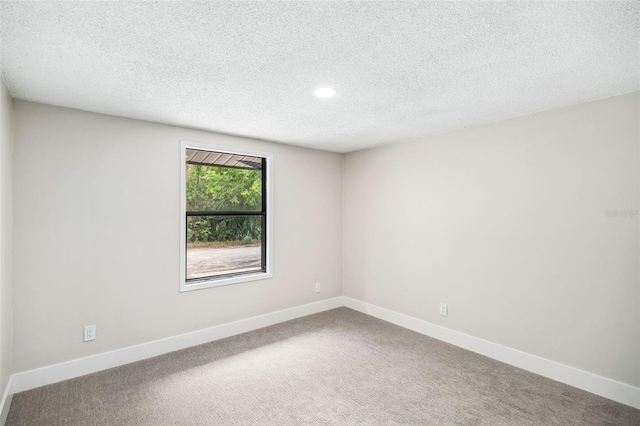 1957 Deloy Dr, Daytona Beach, FL 32119 - carpeted spare room featuring baseboards, a textured ceiling, and recessed lighting