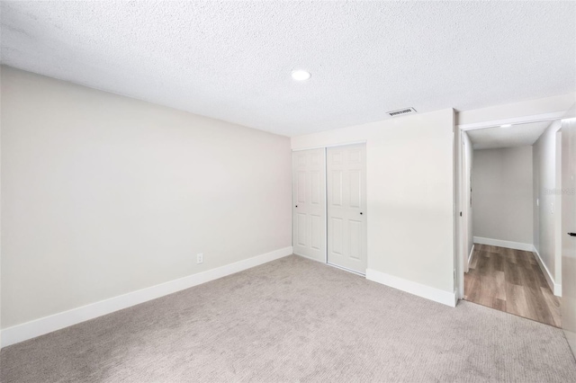 1957 Deloy Dr, Daytona Beach, FL 32119 - unfurnished bedroom with carpet floors, a closet, baseboards, a textured ceiling, and recessed lighting
