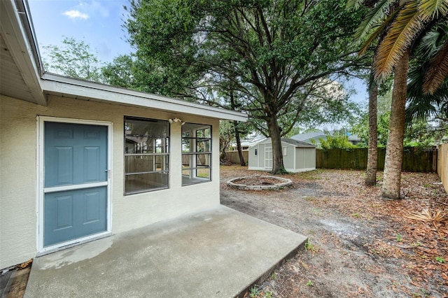 1957 Deloy Dr, Daytona Beach, FL 32119 - view of patio / terrace with a fenced backyard, a storage shed, and an outbuilding