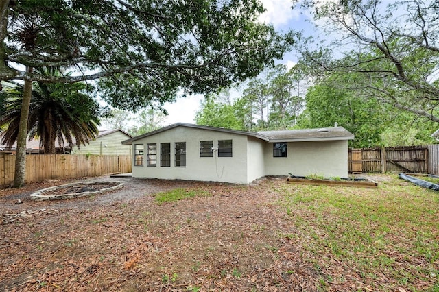 1957 Deloy Dr, Daytona Beach, FL 32119 - back of property featuring stucco siding and a fenced backyard