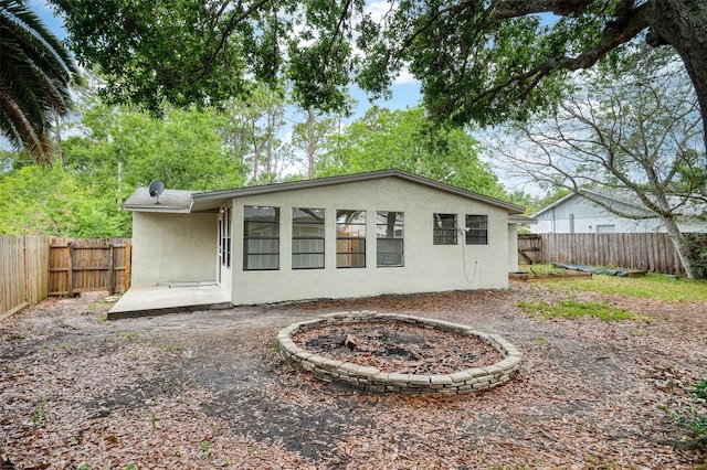 1957 Deloy Dr, Daytona Beach, FL 32119 - back of property with stucco siding and a fenced backyard