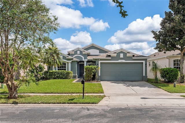 9563 Myrtle Creek Ln, Orlando, FL 32832 - view of front of property with stucco siding, a front lawn, concrete driveway, and a garage