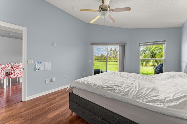 9563 Myrtle Creek Ln, Orlando, FL 32832 - bedroom featuring access to outside, dark wood finished floors, baseboards, ceiling fan, and lofted ceiling