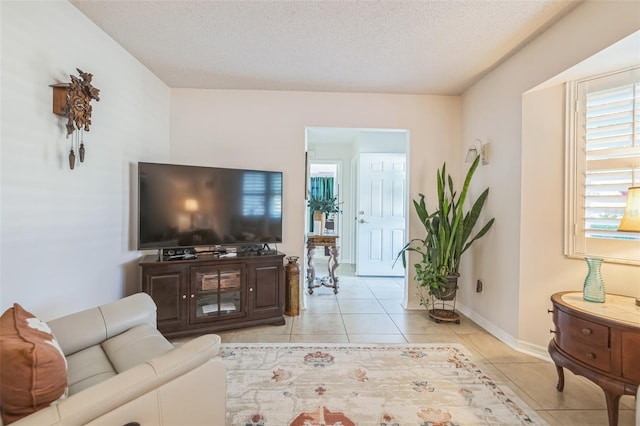 1566 Damask Ln, Sebastian, FL 32958 - living area with light tile patterned floors, baseboards, and a textured ceiling