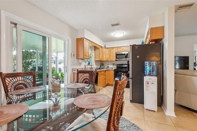 1566 Damask Ln, Sebastian, FL 32958 - dining area with light tile patterned flooring and a textured ceiling