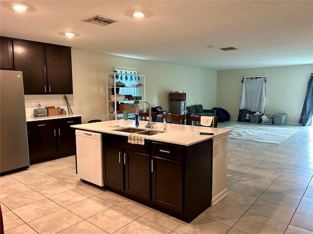 4427 Blackbird St, Kissimmee, FL 34746 - kitchen featuring dishwasher, freestanding refrigerator, a sink, open floor plan, and light countertops