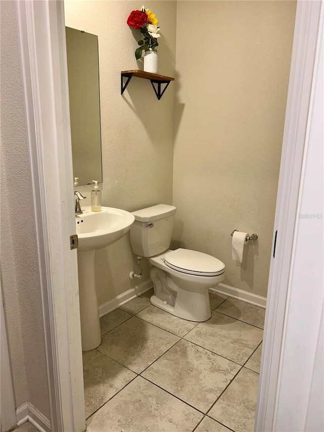 4427 Blackbird St, Kissimmee, FL 34746 - bathroom featuring tile patterned floors, toilet, and baseboards