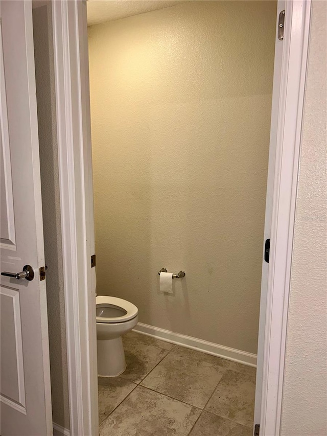 4427 Blackbird St, Kissimmee, FL 34746 - bathroom featuring tile patterned floors, toilet, and baseboards