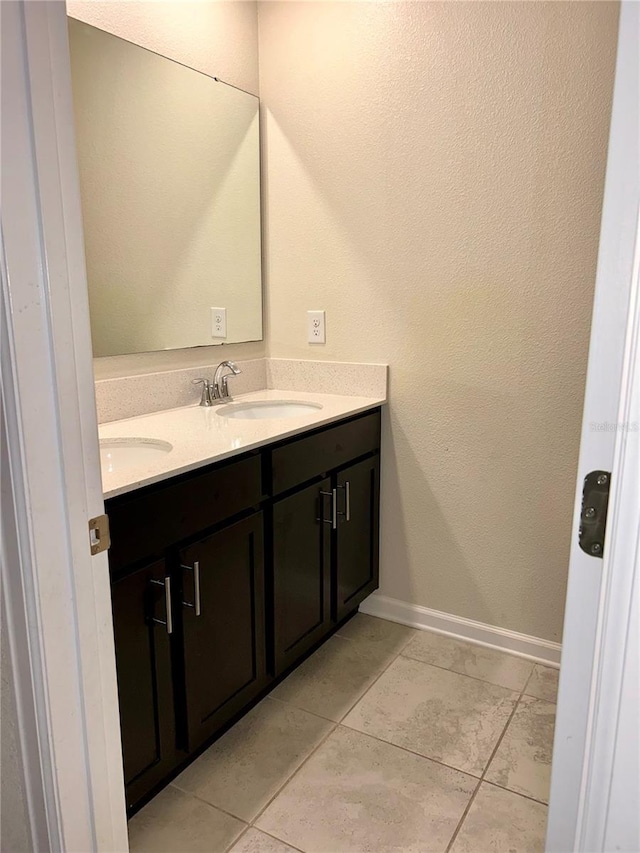 4427 Blackbird St, Kissimmee, FL 34746 - bathroom with double vanity, tile patterned floors, and baseboards