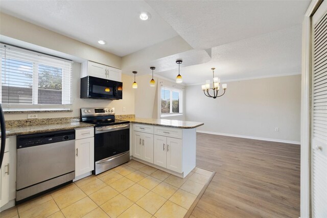 1948 Conway Rd Unit 8, Orlando, FL 32812 - kitchen with appliances with stainless steel finishes, a peninsula, white cabinets, a chandelier, and baseboards