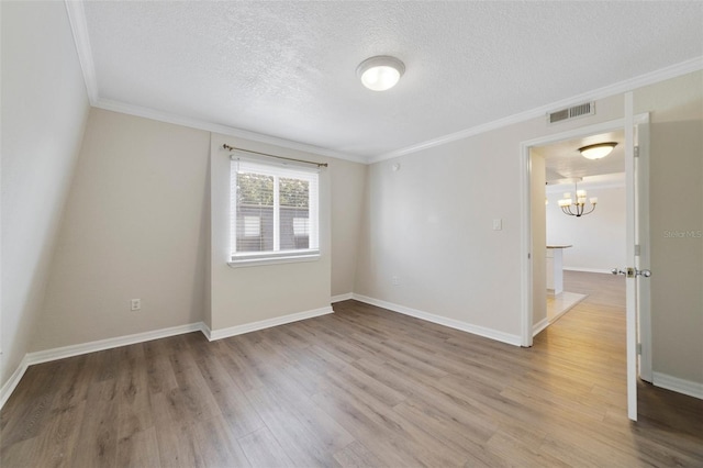 1948 Conway Rd Unit 8, Orlando, FL 32812 - empty room with ornamental molding, a textured ceiling, a chandelier, wood finished floors, and baseboards