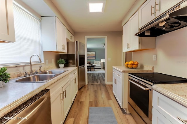 635 San Lanta Cir, Sanford, FL 32771 - kitchen featuring stainless steel appliances, under cabinet range hood, a sink, and white cabinetry