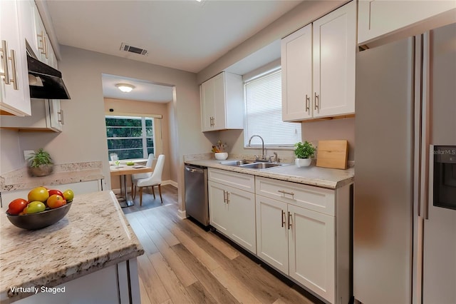 635 San Lanta Cir, Sanford, FL 32771 - kitchen with stainless steel appliances, a sink, light countertops, and white cabinetry