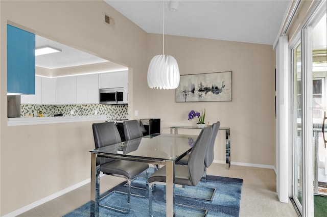 5395 Dover Village Ln Unit 305, Orlando, FL 32812 - dining space with light carpet, lofted ceiling, and baseboards