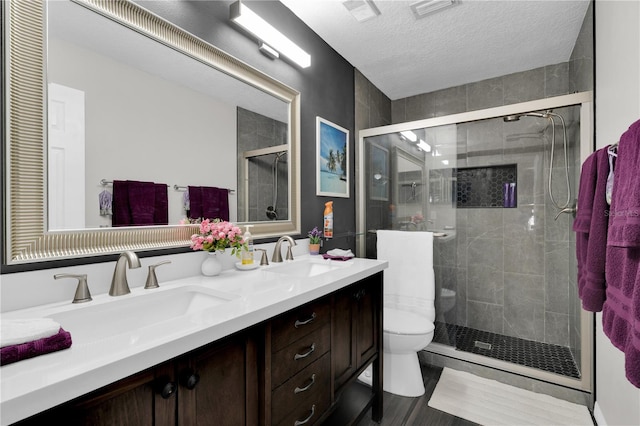 5395 Dover Village Ln Unit 305, Orlando, FL 32812 - bathroom featuring toilet, a shower stall, double vanity, and a textured ceiling