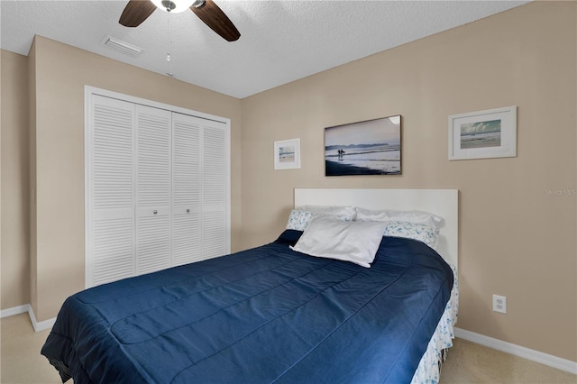 5395 Dover Village Ln Unit 305, Orlando, FL 32812 - bedroom with baseboards, carpet flooring, a closet, a textured ceiling, and ceiling fan