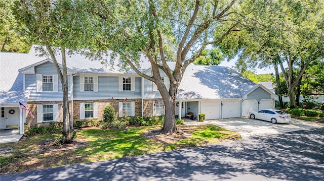 5395 Dover Village Ln Unit 305, Orlando, FL 32812 - view of front facade with a garage, concrete driveway, and brick siding