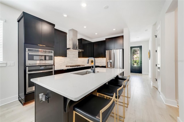 2110 Hillcrest St, Orlando, FL 32803 - kitchen with wall chimney exhaust hood, stainless steel appliances, a sink, decorative backsplash, and baseboards
