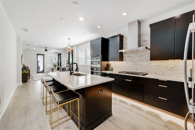 2110 Hillcrest St, Orlando, FL 32803 - kitchen featuring wall chimney range hood, a sink, modern cabinets, tasteful backsplash, and light countertops