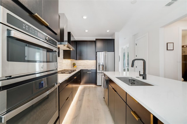 2110 Hillcrest St, Orlando, FL 32803 - kitchen with a sink, stainless steel appliances, light wood-style floors, light countertops, and recessed lighting