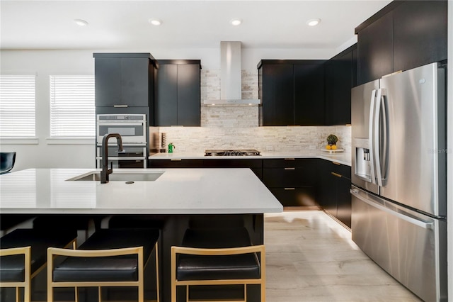 2110 Hillcrest St, Orlando, FL 32803 - kitchen featuring appliances with stainless steel finishes, wall chimney range hood, dark cabinets, light countertops, and recessed lighting