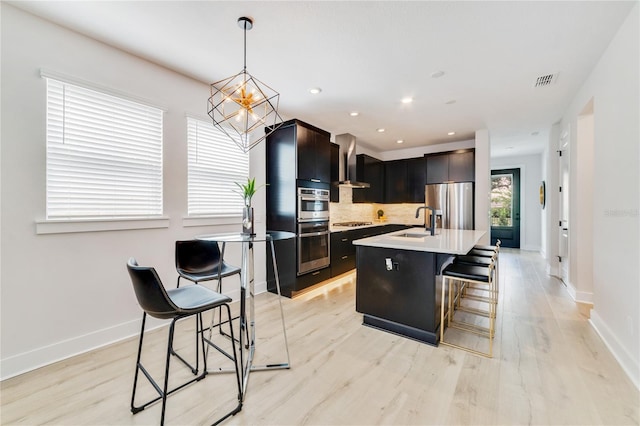 2110 Hillcrest St, Orlando, FL 32803 - kitchen featuring stainless steel appliances, a sink, light countertops, decorative backsplash, and a breakfast bar