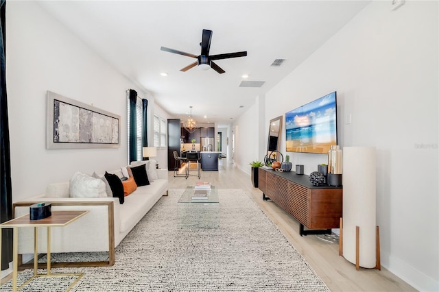 2110 Hillcrest St, Orlando, FL 32803 - living room with a ceiling fan, light wood-style floors, a chandelier, recessed lighting, and baseboards
