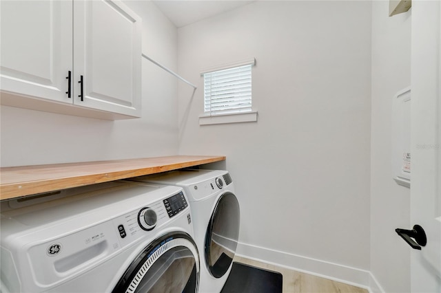 2110 Hillcrest St, Orlando, FL 32803 - laundry room featuring washing machine and dryer, cabinet space, and baseboards