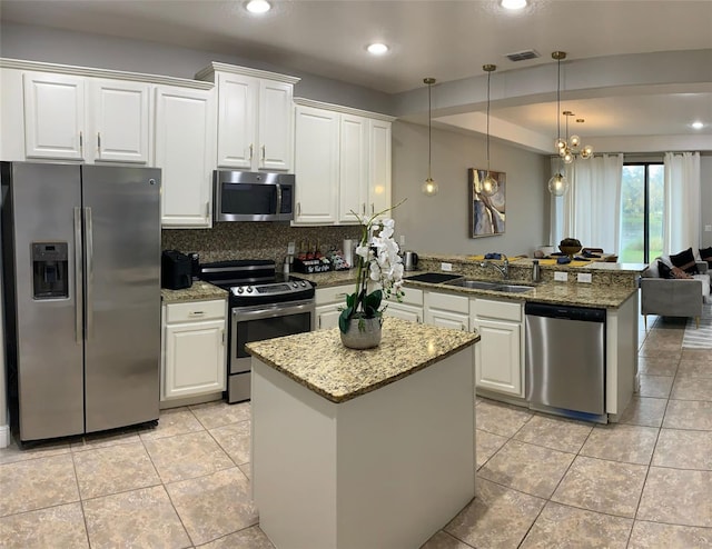 8124 Roseville Rd, Davenport, FL 33896 - kitchen with stainless steel appliances, a peninsula, a sink, white cabinetry, and recessed lighting