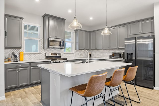 15358 Arcadia Bluff Loop, Winter Garden, FL 34787 - kitchen with stainless steel appliances, gray cabinetry, light wood-style flooring, a sink, and recessed lighting
