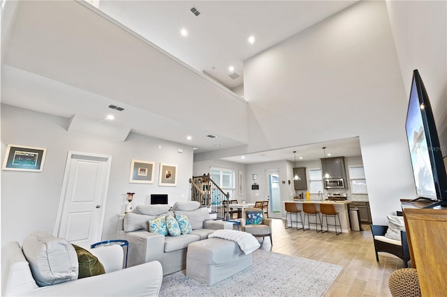 15358 Arcadia Bluff Loop, Winter Garden, FL 34787 - living area featuring stairs, light wood-style flooring, and recessed lighting