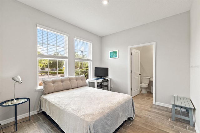 15358 Arcadia Bluff Loop, Winter Garden, FL 34787 - bedroom featuring wood finished floors, baseboards, and ensuite bathroom