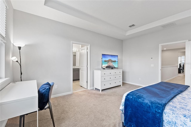 15358 Arcadia Bluff Loop, Winter Garden, FL 34787 - bedroom with light colored carpet, a tray ceiling, baseboards, and connected bathroom