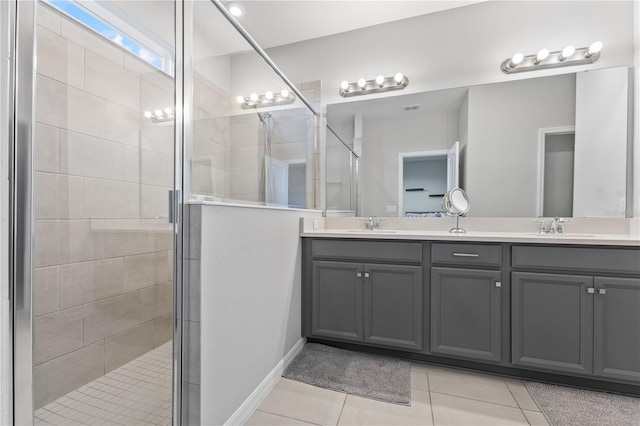 15358 Arcadia Bluff Loop, Winter Garden, FL 34787 - bathroom with tile patterned floors, a stall shower, double vanity, and baseboards