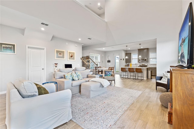 15358 Arcadia Bluff Loop, Winter Garden, FL 34787 - living room with stairs, light wood finished floors, recessed lighting, and baseboards